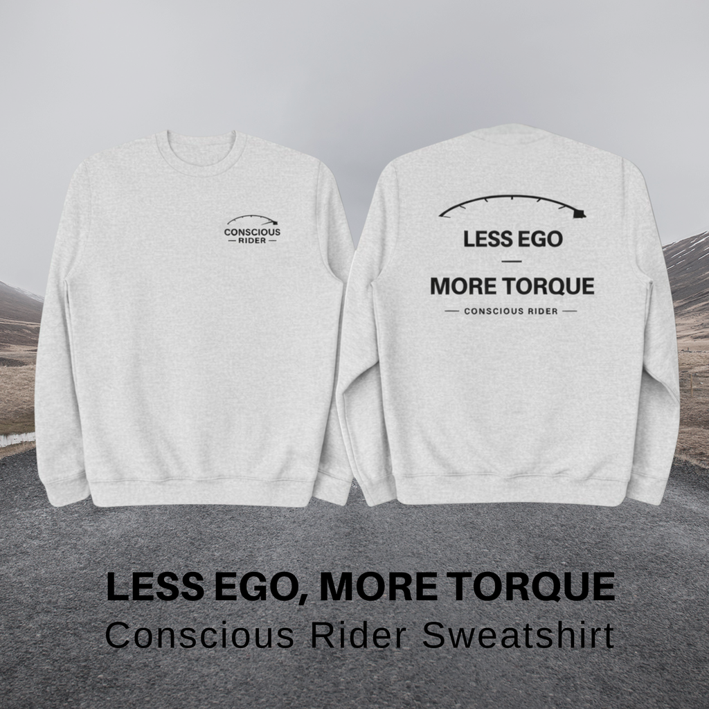 “Black motorcycle crewneck sweatshirt with Conscious Rider front logo and ‘Less Ego More Torque’ graphic on the back, worn by a man on a mountain road.”
