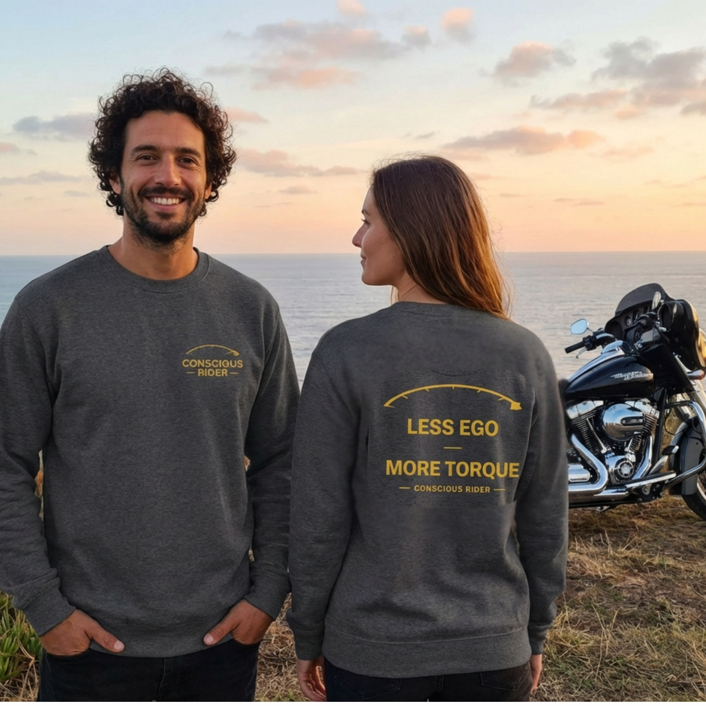 “Black motorcycle crewneck sweatshirt with Conscious Rider front logo and ‘Less Ego More Torque’ graphic on the back, worn by a man on a mountain road.”
